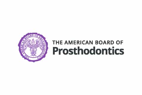 Logo of the American Board of Prosthodontics featuring a purple seal with a bird symbol and text beside it.