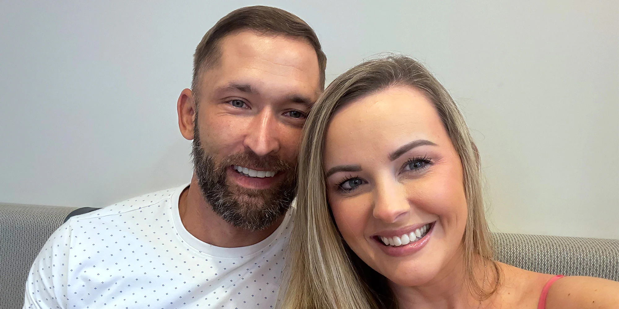 David and wife taking a selfie to show off new full mouth dental implants from Envision in Charlotte